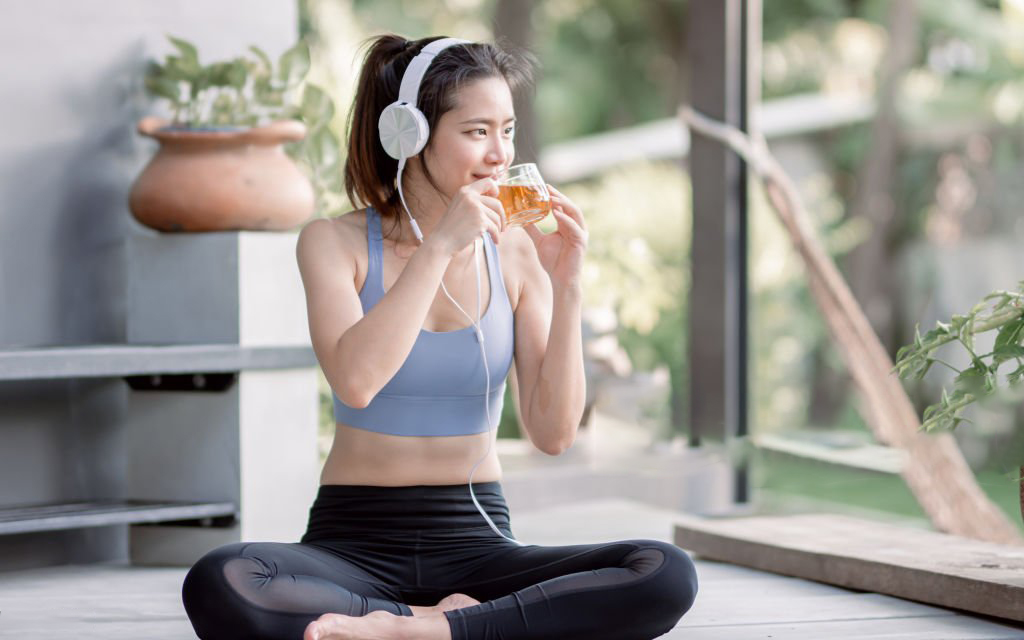 Lady working out with drinking tea